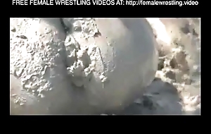 Gals wrestling on touching a catch mud